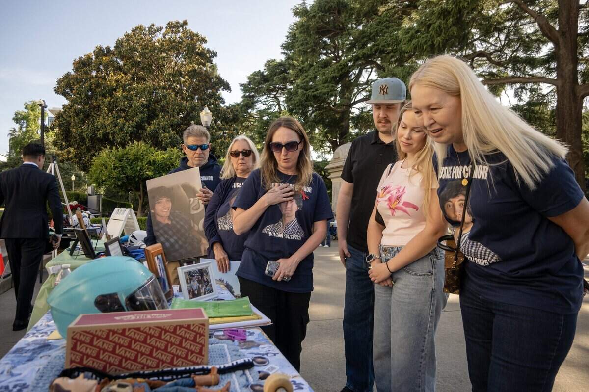 Allison Lyman, center, mother of Connor Lopez, displays some of Connor’s belongings at the memorial rally for victims of vehicular violence at the California Capitol on April 23.